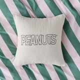 Cream cotton cushion cover with PEANUTS logo centered on front