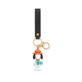 Snoopy scout keychain with black strap, orange-hat character charm, gold keyring