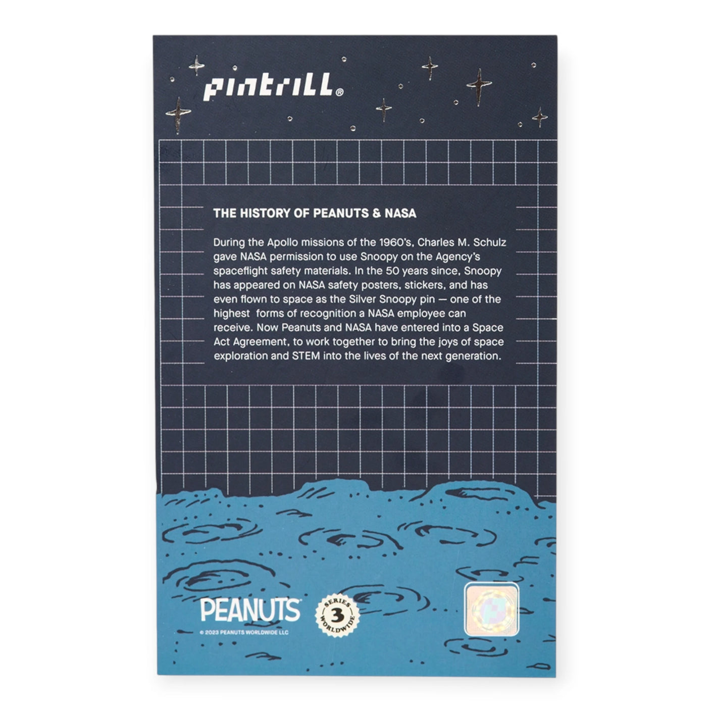 Peanuts NASA history pin backer card with dark grid and blue space illustration