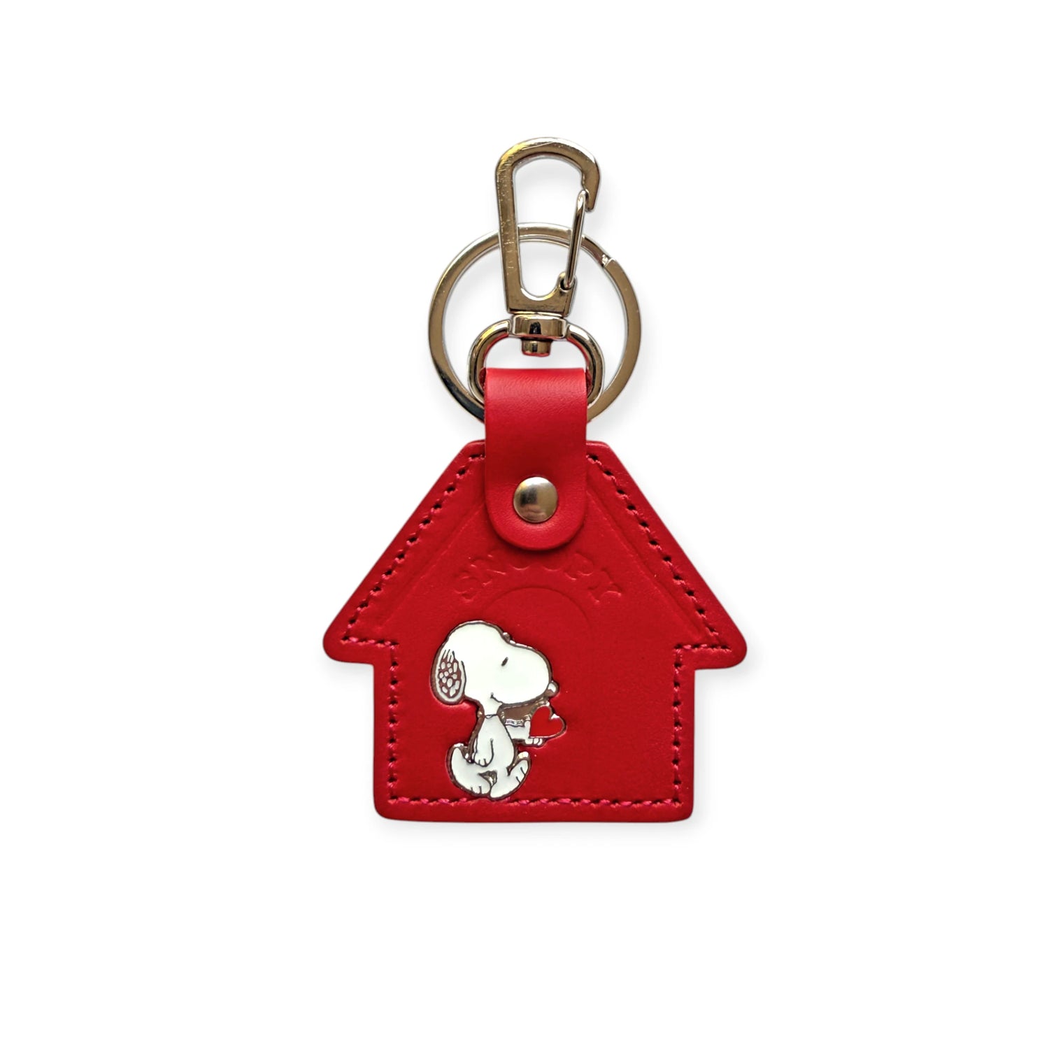 Red leather keychain shaped like Snoopy’s red kennel with enamel Snoopy figure walking in front.
