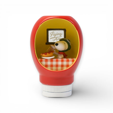 Red sauce bottle figurine featuring Snoopy as Flying Ace with pilot helmet and scarf inside a cozy diner scene