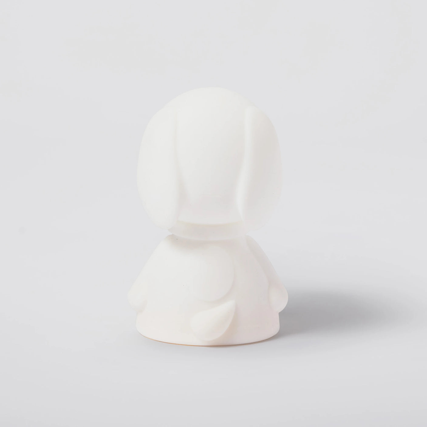 The Snoopy Night Light (11cm), a white sculpted figurine reminiscent of the beloved dog, is set against a minimalist backdrop, capturing the playful essence of Snoopy branding.