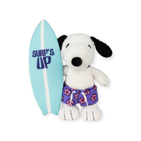 Front view of Snoopy plush in purple floral shorts holding blue surfboard with Surf's Up text on white background