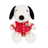 A limited edition Snoopy Plush from the Snoopy brand is seated upright, wearing an appealing red and white varsity jacket with a patch, all set against a crisp white backdrop.