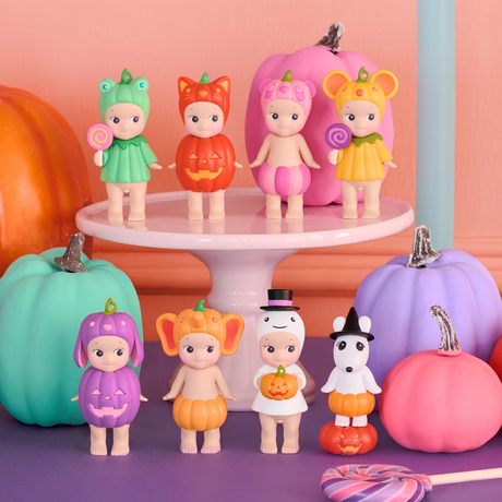 Sonny Angel mini figures in Halloween outfits on a pedestal with pumpkins