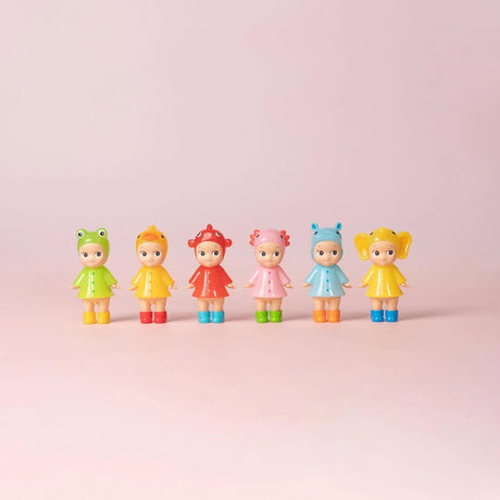 Six pastel character figurines in rain outfits lined up