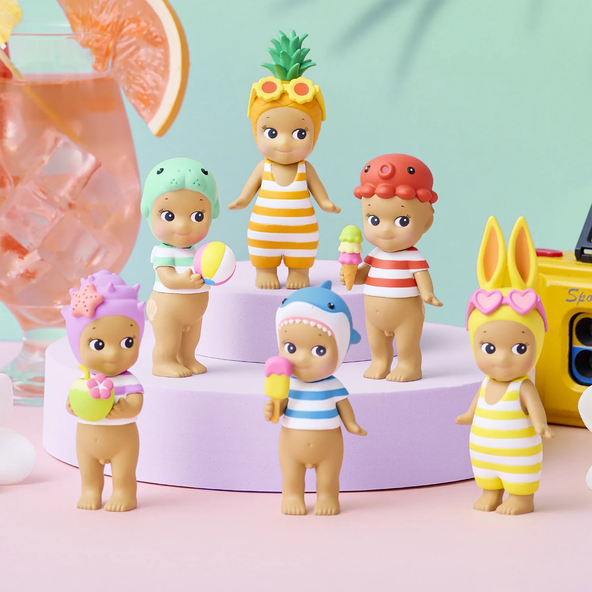 Sonny Angel Summer Vacation Sun Kissed figurines, yellow striped outfits and fruit-themed accessories