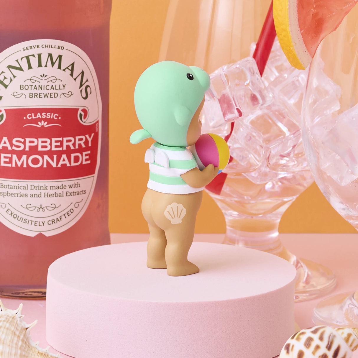 Sonny Angel Summer Vacation Sun Kissed figurine holding a pink drink can on white pedestal