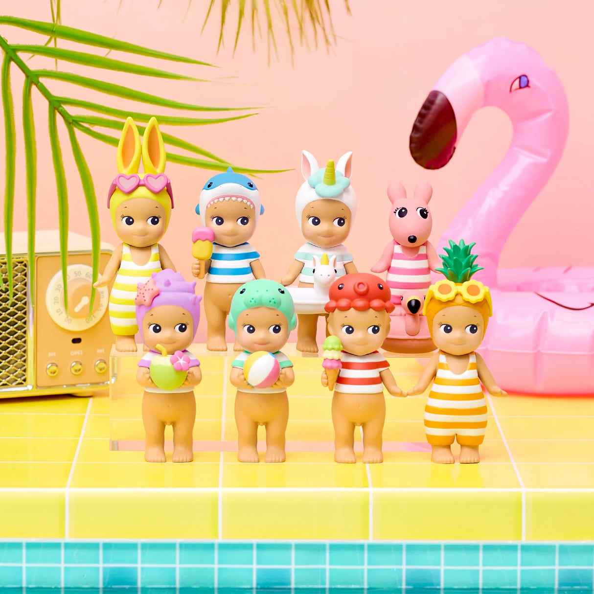 Sonny Angel Summer Vacation Sun Kissed figurines lineup, striped swimsuits near flamingo prop