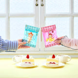 Two sweet candy cases with key chains on display