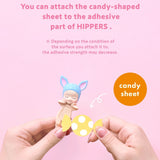 Adhesive candy sheet attachment with small character figure in hands