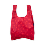 Red polka dot reusable tote bag with U-shaped opening, circular pattern