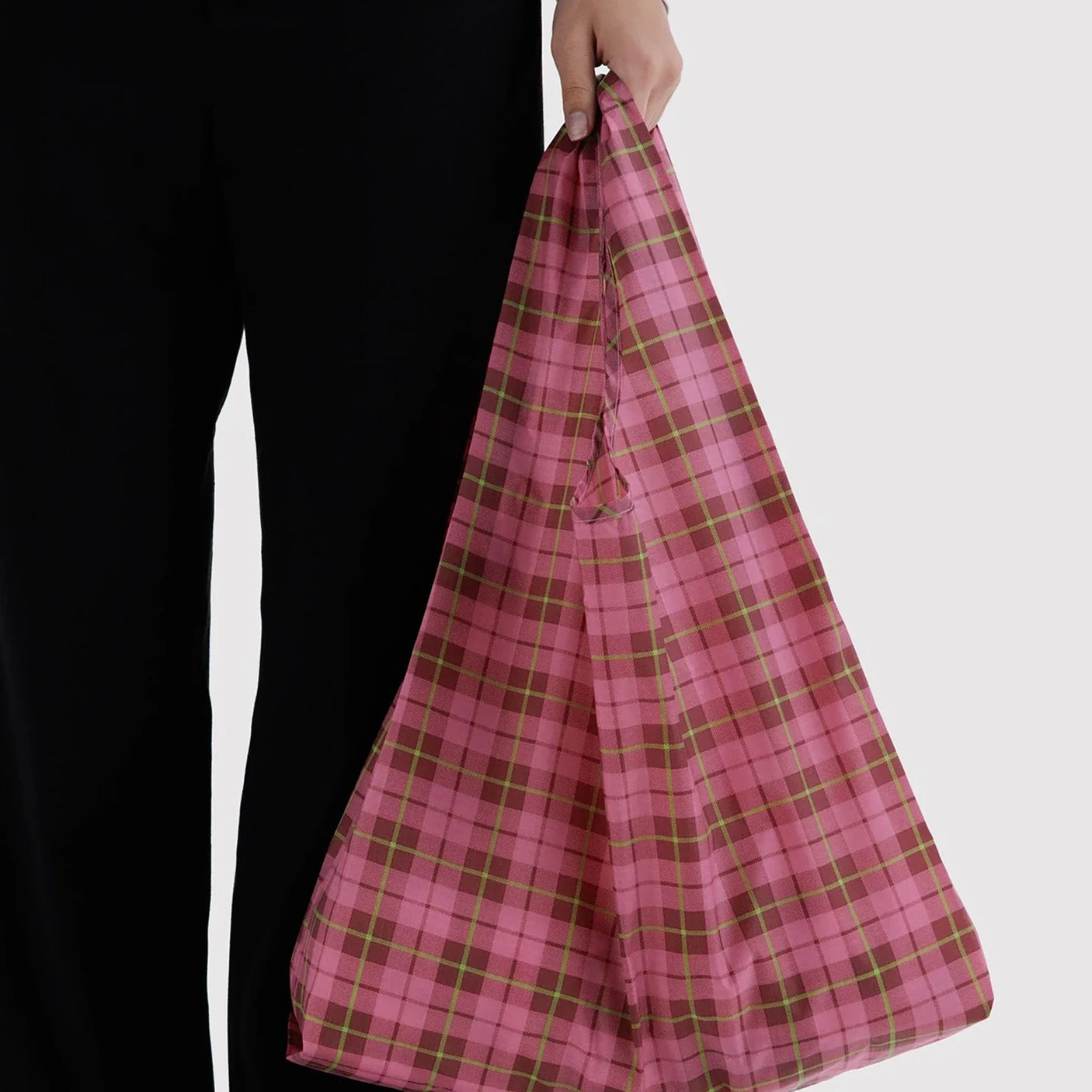 Standard Baggu reusable tote bag, pink plaid tartan, held by top handle