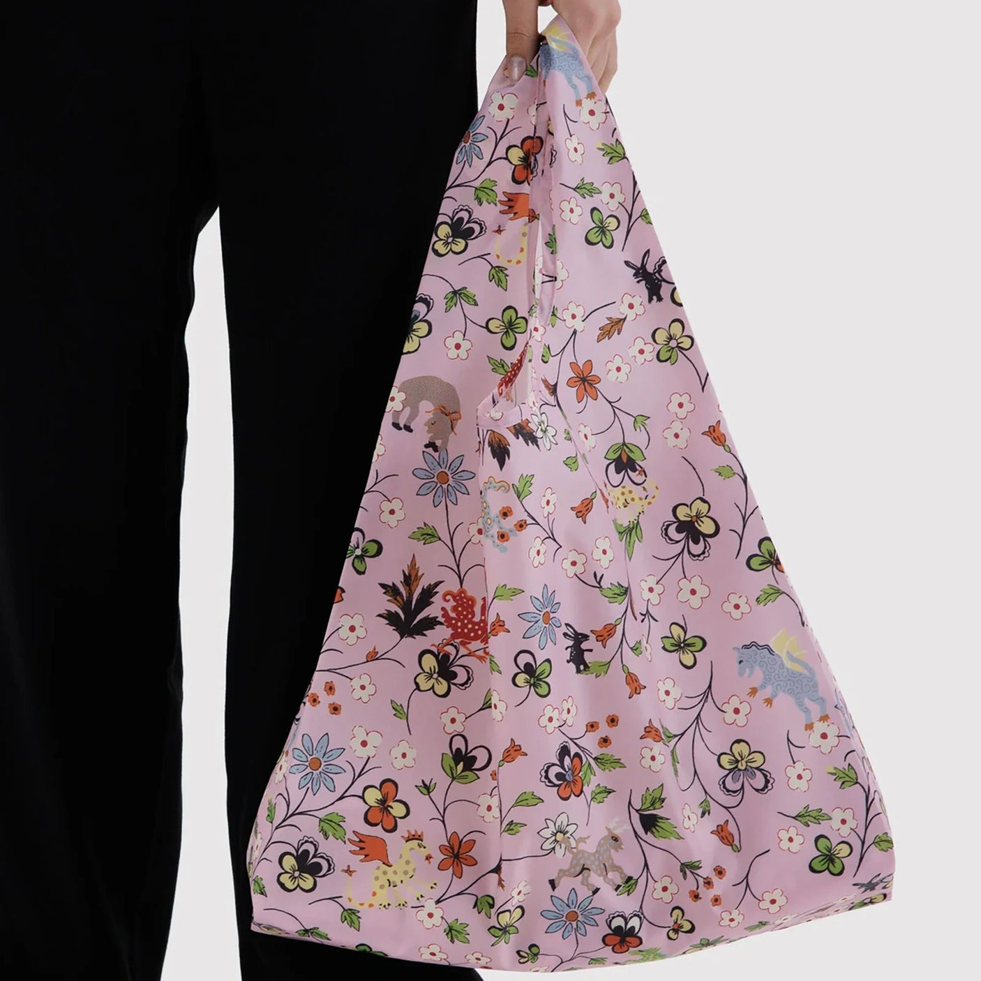 BAGGU tote bag held in hand, pink floral and butterfly print