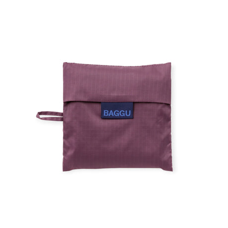 Baggu Standard bag folded into pouch in wild plum, blue Baggu logo label
