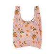 The Baggu Standard Baggu Bag in Apricots & Ribbons design showcases a chic orange and green fruit pattern on light pink, crafted from recycled ripstop nylon.