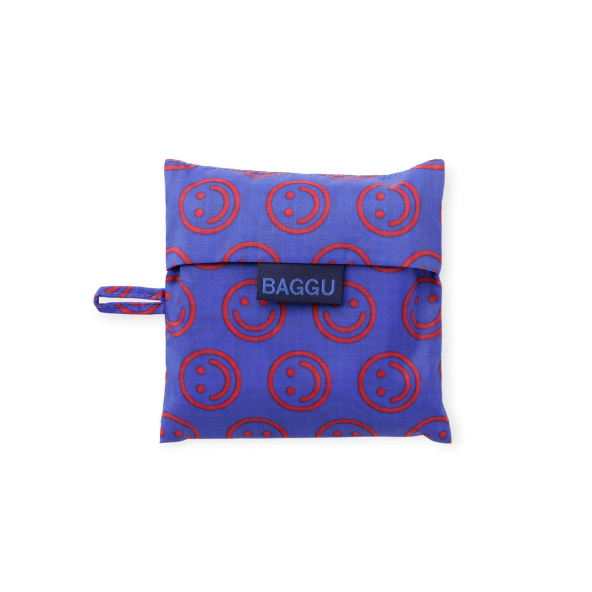 Folded mini Baggu tote pouch with BAGGU label and red smiley circle pattern