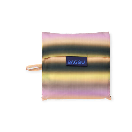 Folded square pouch with horizontal gradient stripes in pink, yellow, and dark green, featuring a blue label and side loop