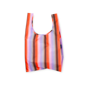 Lightweight reusable shopping bag with vertical orange, purple, and black gradient stripes and rounded handles on white background