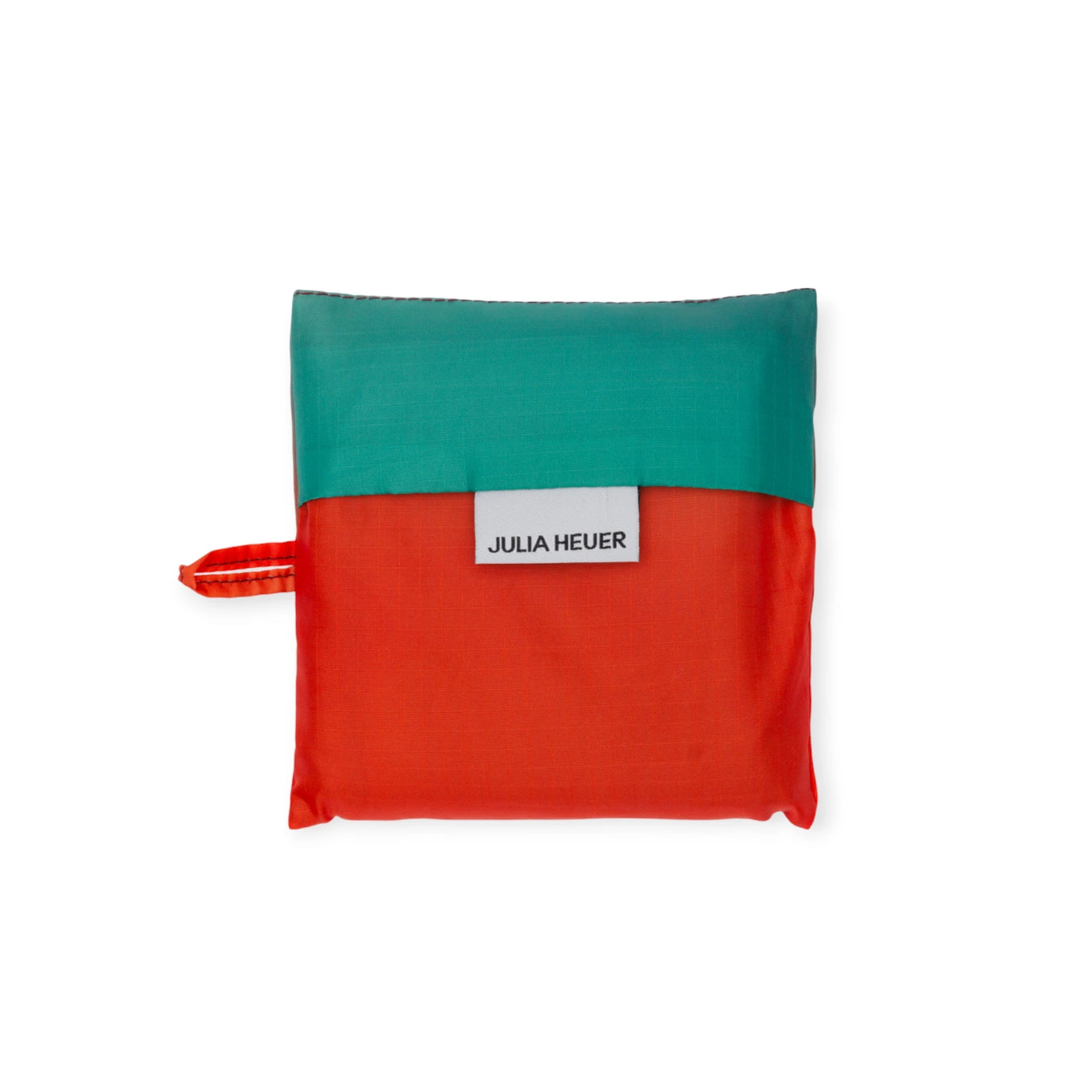 The Standard Baggu x Julia Heuer - Rain is a chic square pouch with a red bottom and green top, featuring the "Julia Heuer x Baggu" label. Made from recycled nylon, it has a small side loop for easy carrying, making it an ideal eco-friendly, reusable bag companion.