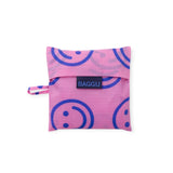 Pink foldable tote pouch with navy smiley pattern and BAGGU label