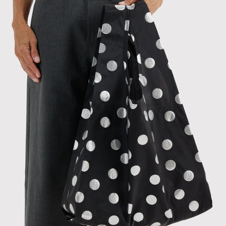 Baggu polka-dot tote bag worn on shoulder, black with silver dots