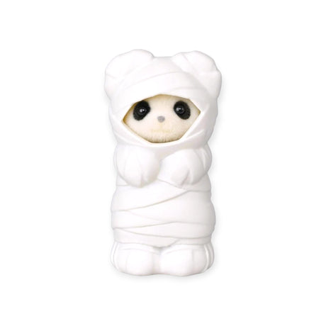 White animal baby figurine in a hooded chef-style outfit