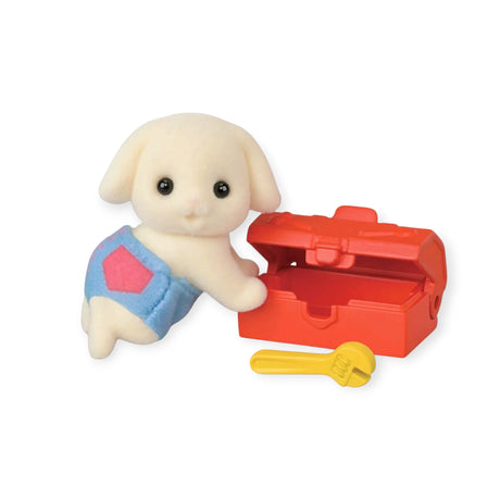 A small toy rabbit in blue overalls stands by an open red toolbox with a yellow wrench, just like the charming figures from Sylvanian Families Blind Bag - Baby Builder by Sylvanian Families.