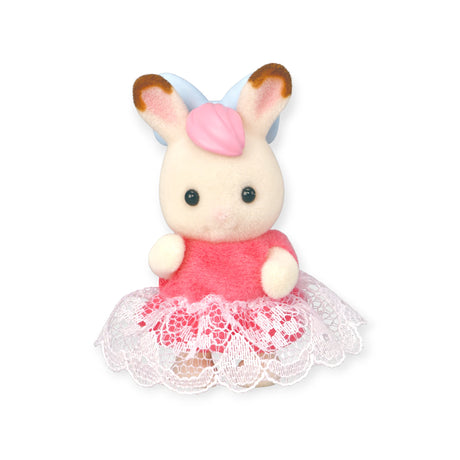 Sylvanian Families Blind Bag - Baby Fun Hair: Features a stuffed rabbit with brown-tipped ears, blue bow, pink dress, and white lace trim, set against a white background. A charming addition to any Sylvanian Families collection.