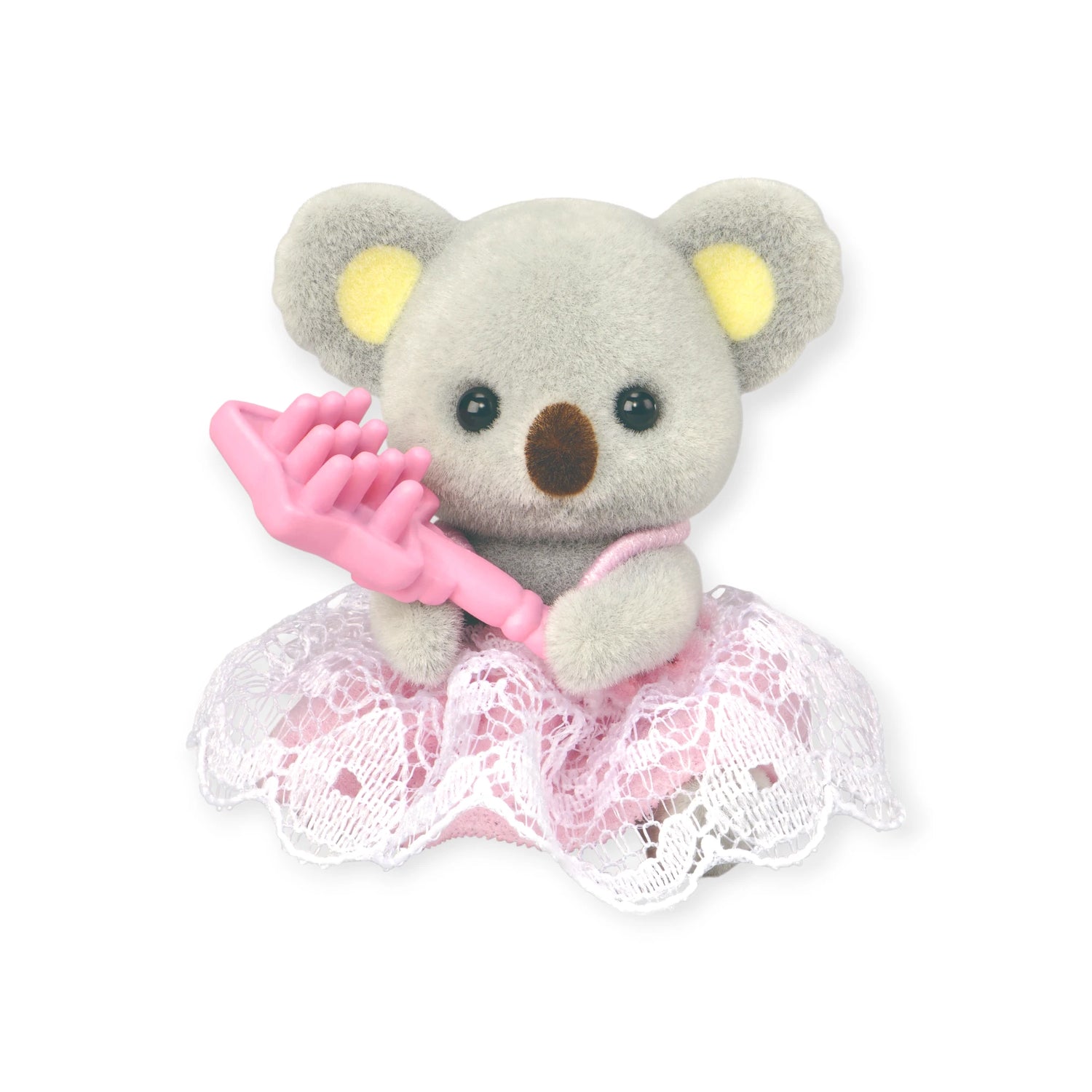 The Sylvanian Families Blind Bag - Baby Fun Hair features a small plush koala in a pink and white lace dress, holding a pink hairbrush—an adorable collectible by Sylvanian Families.