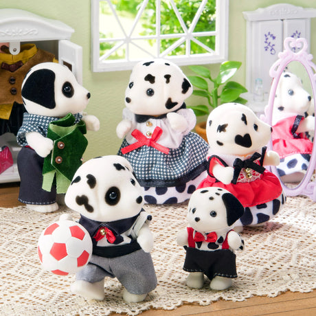 Dalmatian plush family group with houndstooth outfits and red accessories on floor