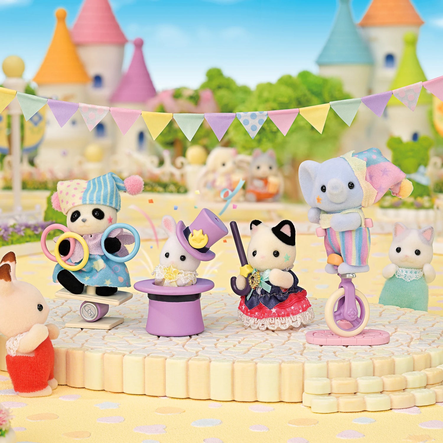 Sylvanian Families - Dream Showtime Babies featuring five plush animal babies dressed in colorful circus costumes with accessories outdoors