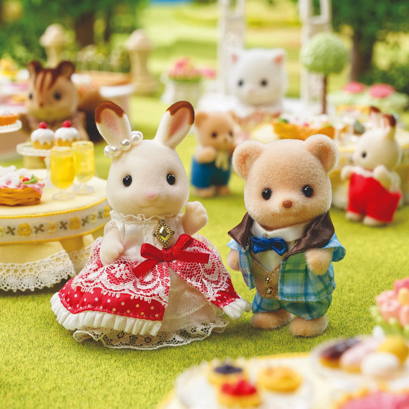 Sylvanian Families - Freya & Theo Anniversary Friends Set featuring plush rabbit and bear dressed in detailed clothing outdoors