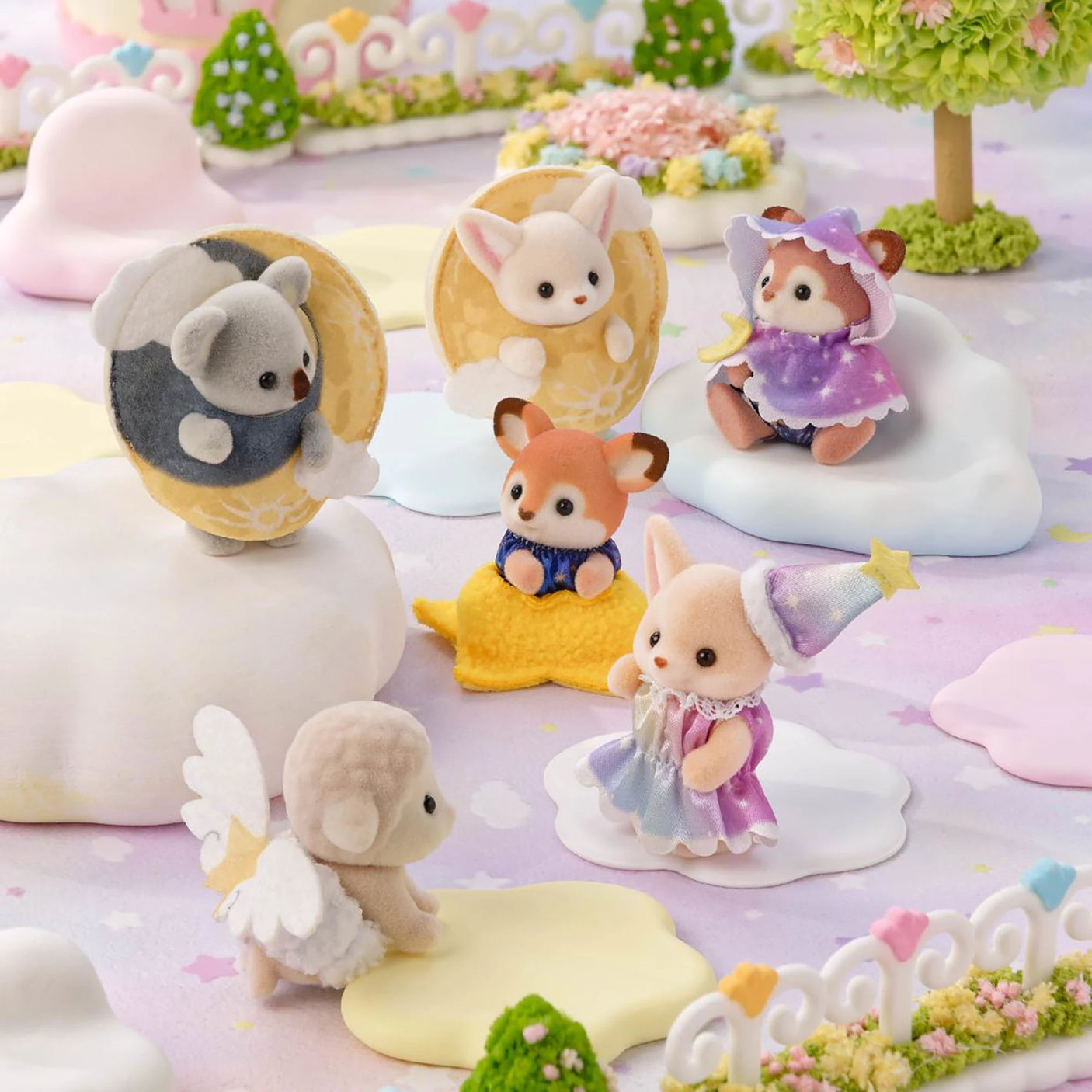 Assorted baby animal figurines with moon and star costumes in a pastel display
