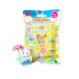 A toy rabbit figurine with a pink umbrella stands beside the Sylvanian Families Blind Bag - Blooming Baby Friends packaging, featuring delightful animal mini figures.