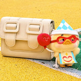 Vinyl plush duck keychain wearing a blue check hat with red glasses, on strap.