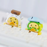 Upset Duck Blind Box - Status Display showing two small yellow ducks in unique costumes, leaning on a white keyboard by Upset Duck