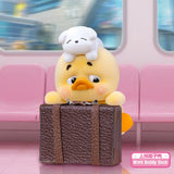 Upset Duck Blind Box - Status Display showing a small yellow duck with a dog figure on its head holding a brown briefcase by Upset Duck