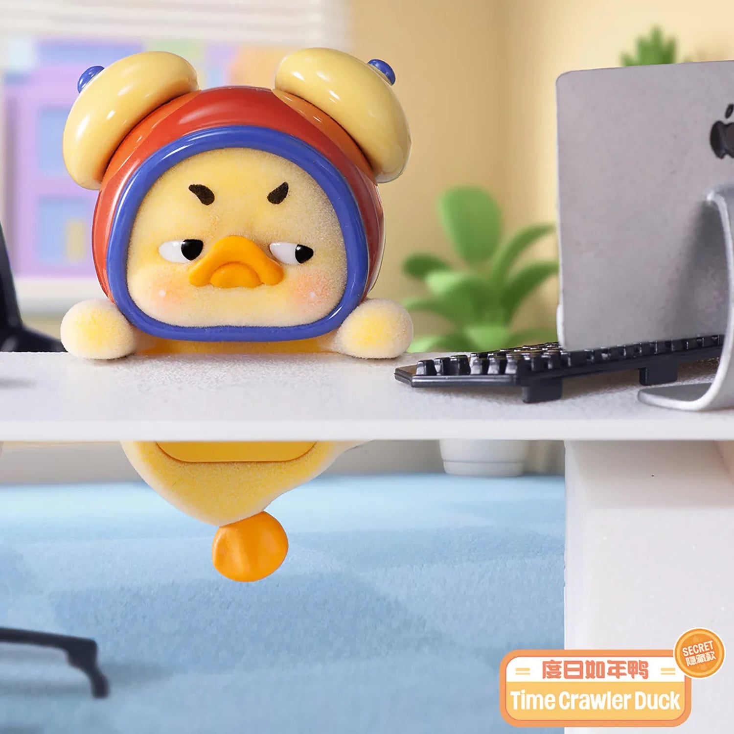 Upset Duck Blind Box - Status Display showing a grumpy yellow duck in a red and yellow alarm clock costume at a desk by Upset Duck