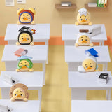 Upset Duck Blind Box - Status Display showing seven small yellow ducks with various costumes and expressions at white desks by Upset Duck
