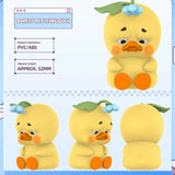 Upset Duck Blind Box - Stop The Spiral showing a yellow duck with a leaf and blue berry hat, sad eyes, and orange feet by Upset Duck