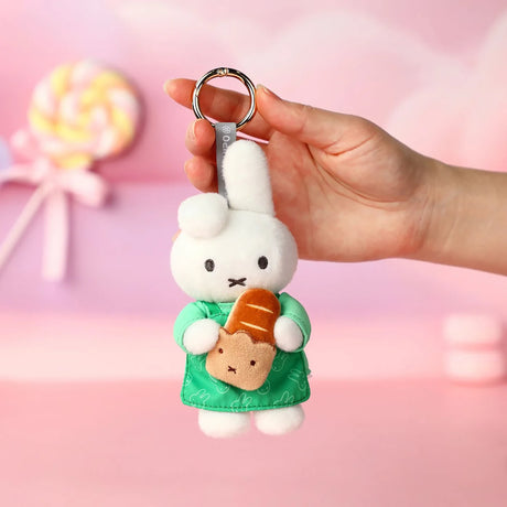 Rabbit plush keychain in green dress with orange carrot accessory