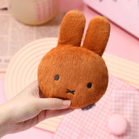 Brown plush rabbit pouch keychain held in hand, with zipper and key ring
