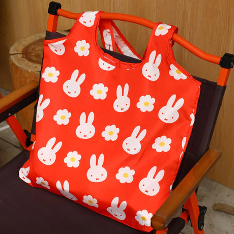Red miffy tote bag with bunny and flower pattern, shown on a stroller