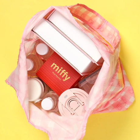 Pink tote bag with visible items inside and open top