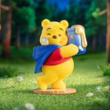 Winnie the Pooh figurine holding a blue lantern-shaped jar with a star