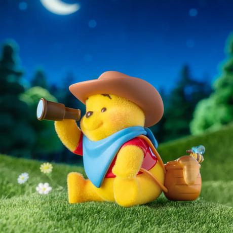 Winnie the Pooh figurine in a cowboy hat holding a brown watering can