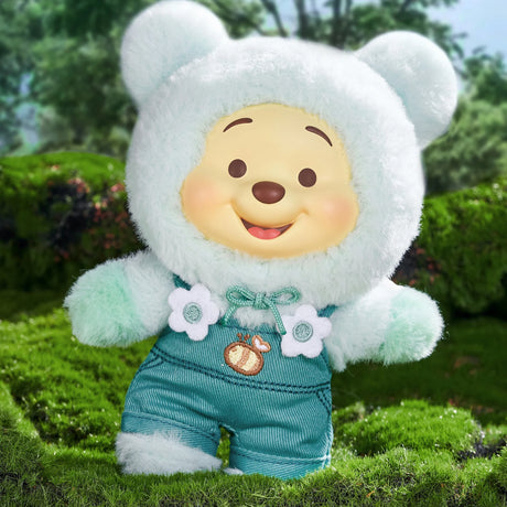 Winnie the Pooh Candy Bear plush in soft white fuzzy bear hood and pastel teal outfit with flower details outdoors