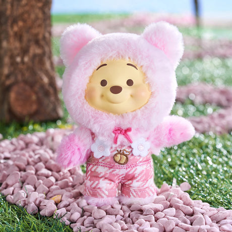 Winnie the Pooh Candy Bear vinyl plush in pastel pink fuzzy bear costume with floral and honey pot details outdoors