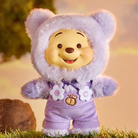 Winnie the Pooh Candy Bear plush figure in pastel purple fuzzy bear suit with flower and honey pot details outdoors